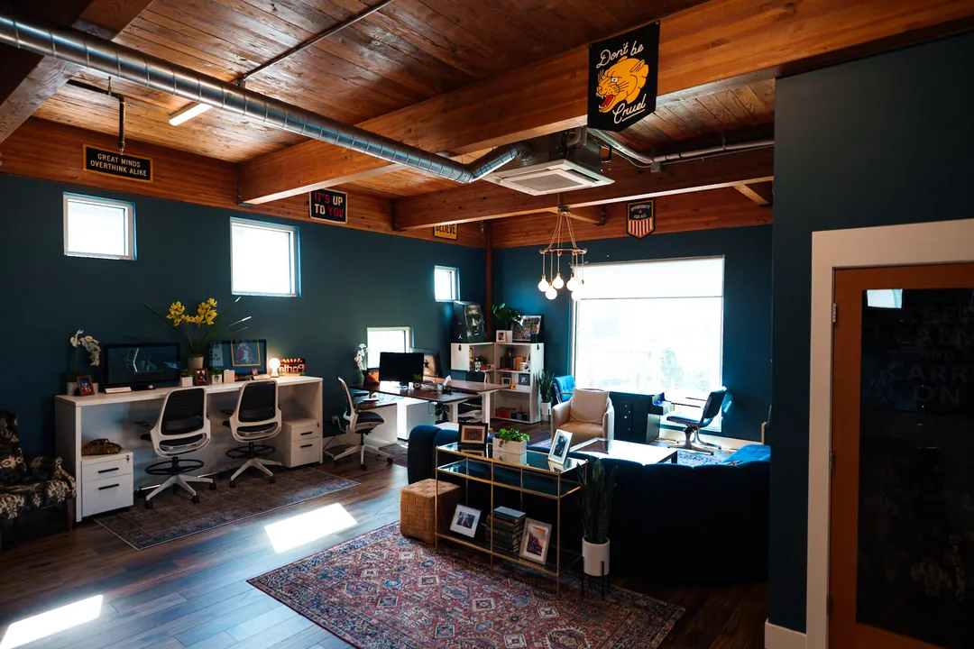 TEDxPortland HQ: workspace corner with desks, a pendant light and a chalkboard wall